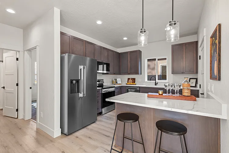 A kitchen inside a kit culture kit home with stunning marble countertops and stainless steel LG appliances