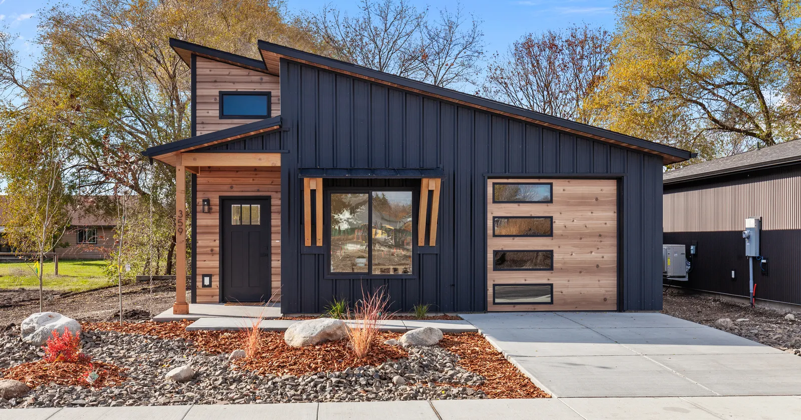Modern prefab home kit exterior in Idaho with black metal and wood siding
