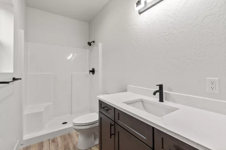 Bathroom with quartz vanity and tub-shower in a 994 Modern kit home built in Idaho