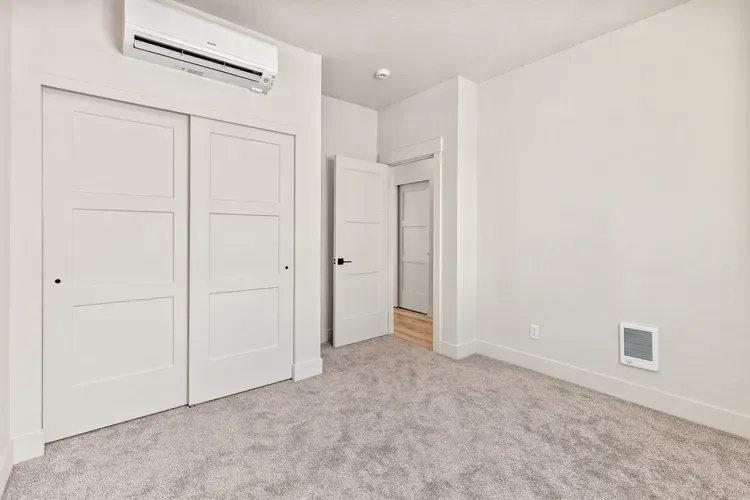 Bedroom in a compact cottage sized for a backyard ADU you could build in Oregon