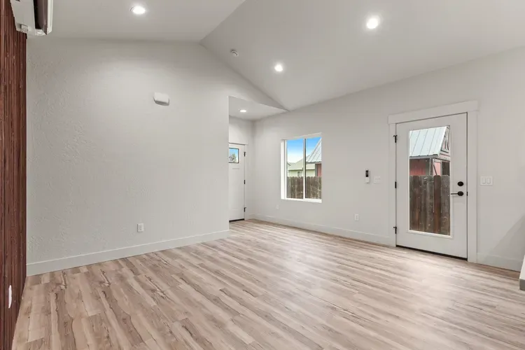 Open living area with vaulted ceiling in a finished home, the end result behind prefabricated homes for sale
