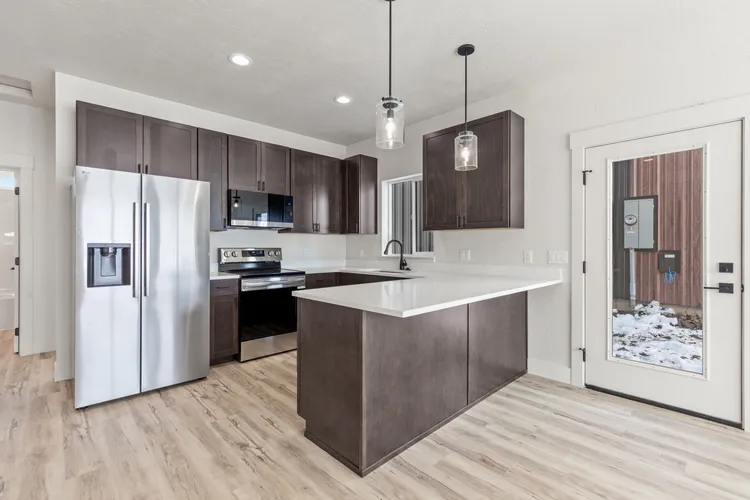 Kitchen inside a Kit Culture cottage model, the finish level a cottage home kit includes