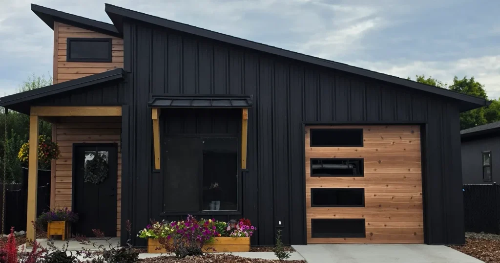 Modern Cottage kit home exterior in Idaho with black metal and wood siding, built from a guest house kit sized package